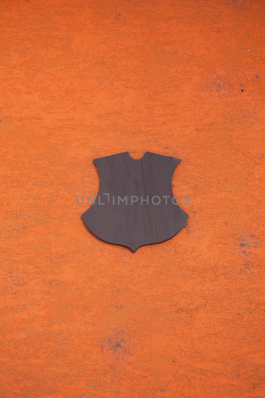 Orange wall with a cartouche in the form of a board as a background for design