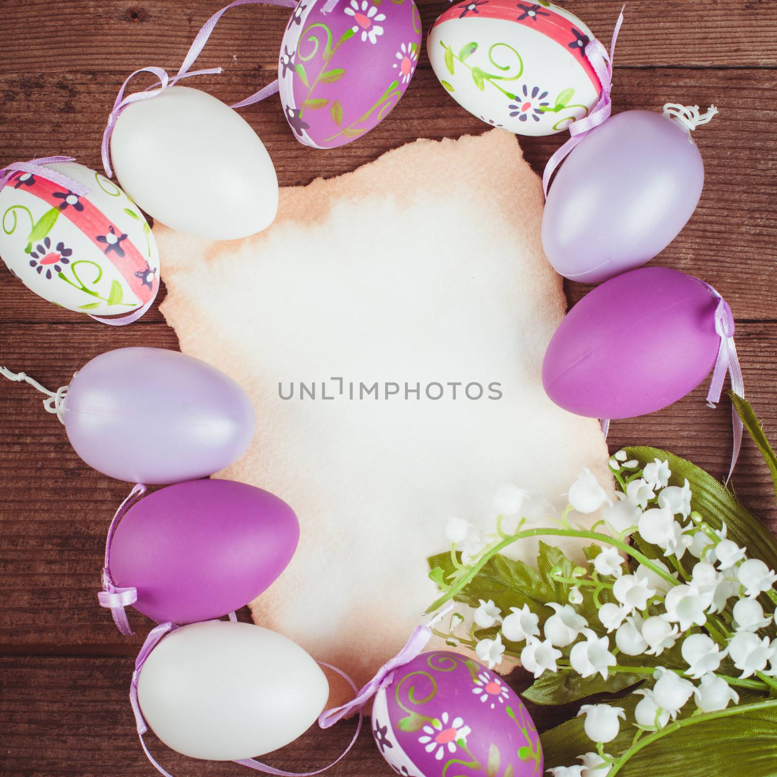 Purple and white eggs and empty greeting card. Easter decorations