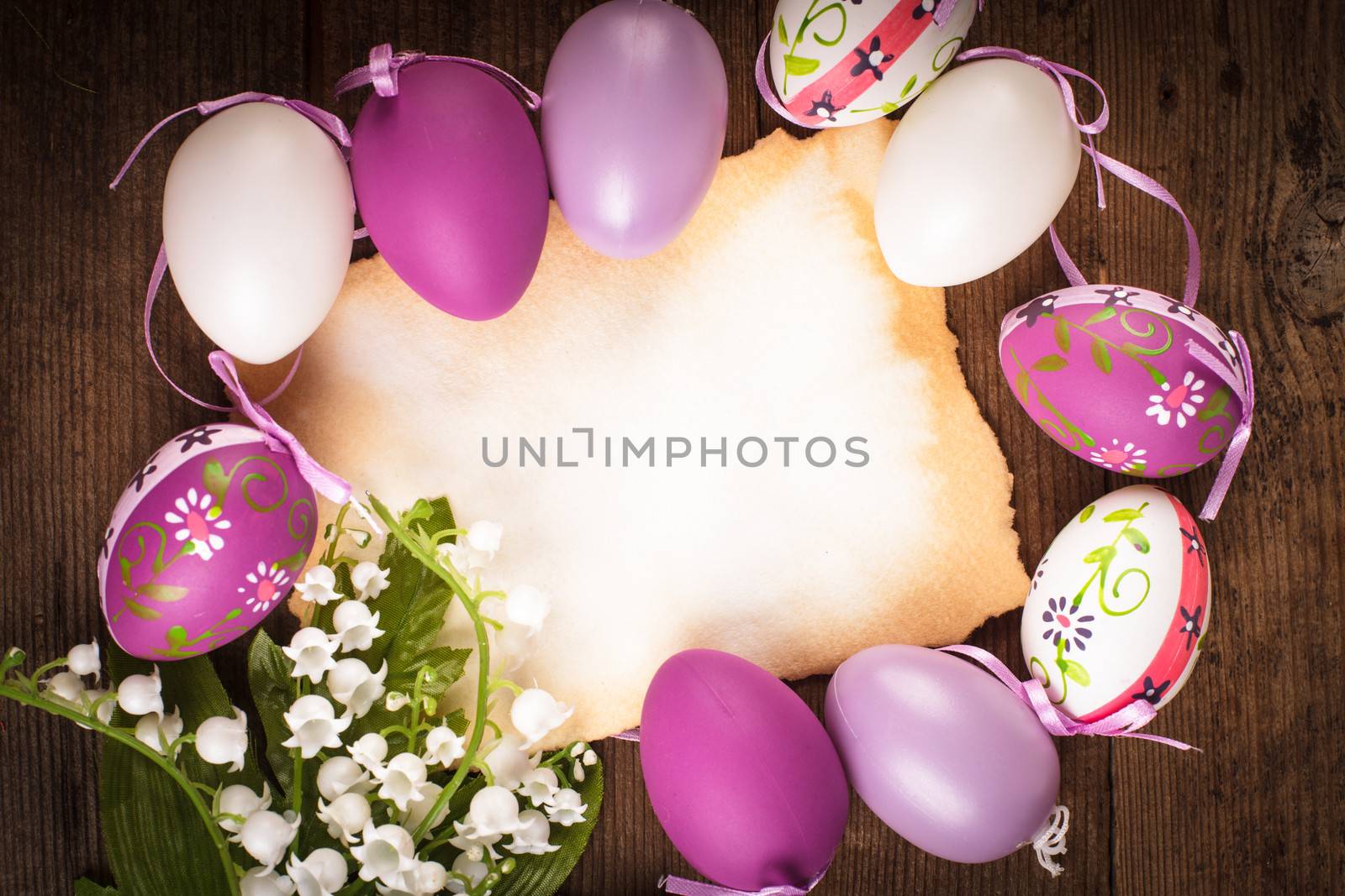 Purple and white eggs and empty greeting card. Easter decorations