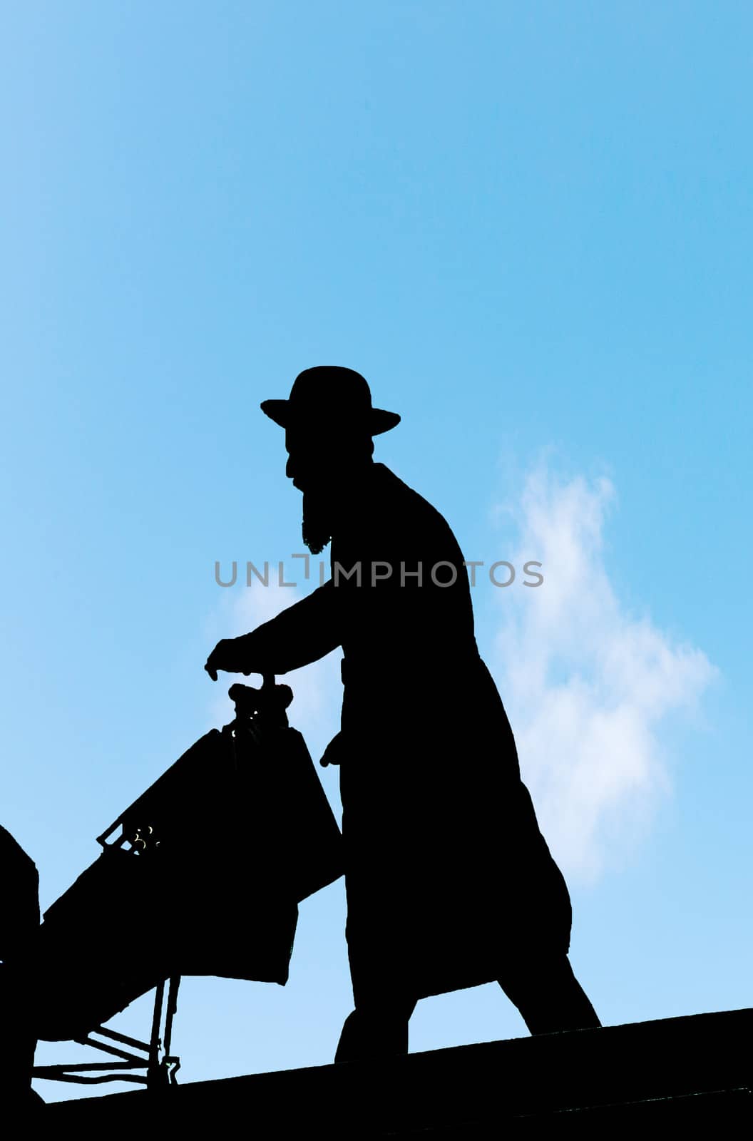 silhouette of orthodox jewish man mith a buggy