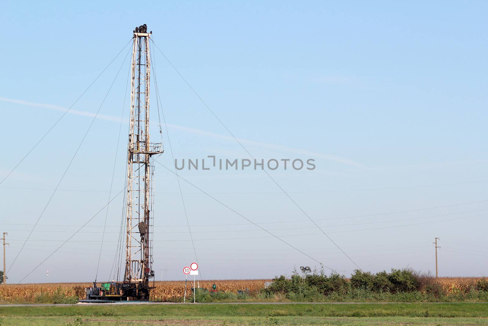 field with oil drilling rig industry by goce