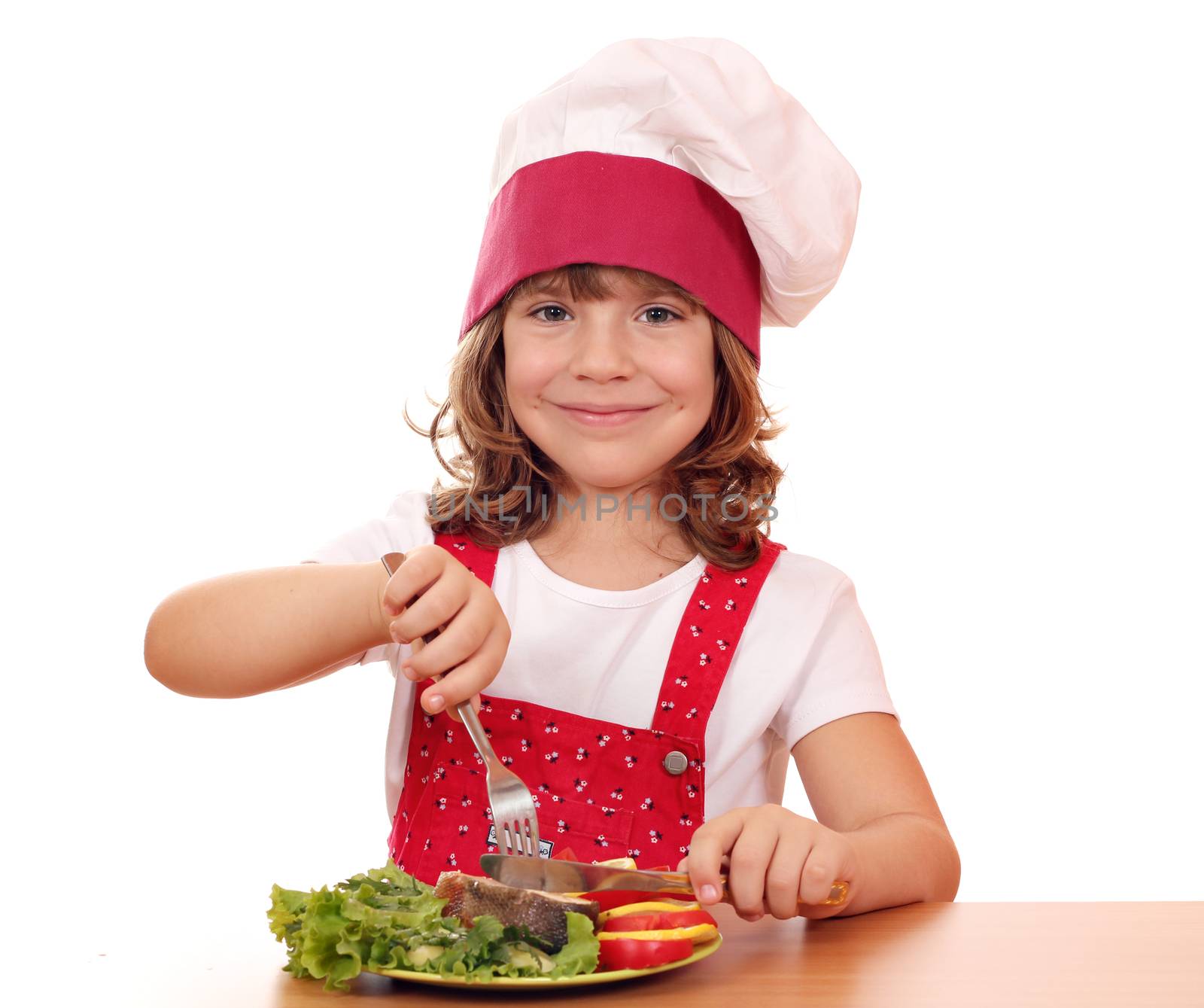 happy little girl cook eat salmon seafood by goce