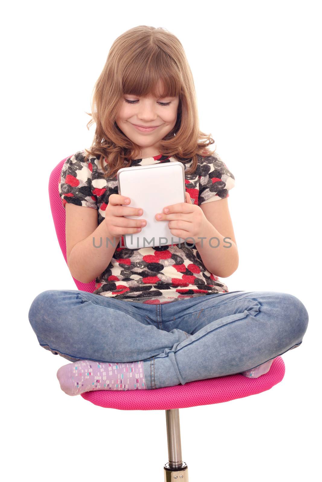 little girl with tablet sitting on chair by goce