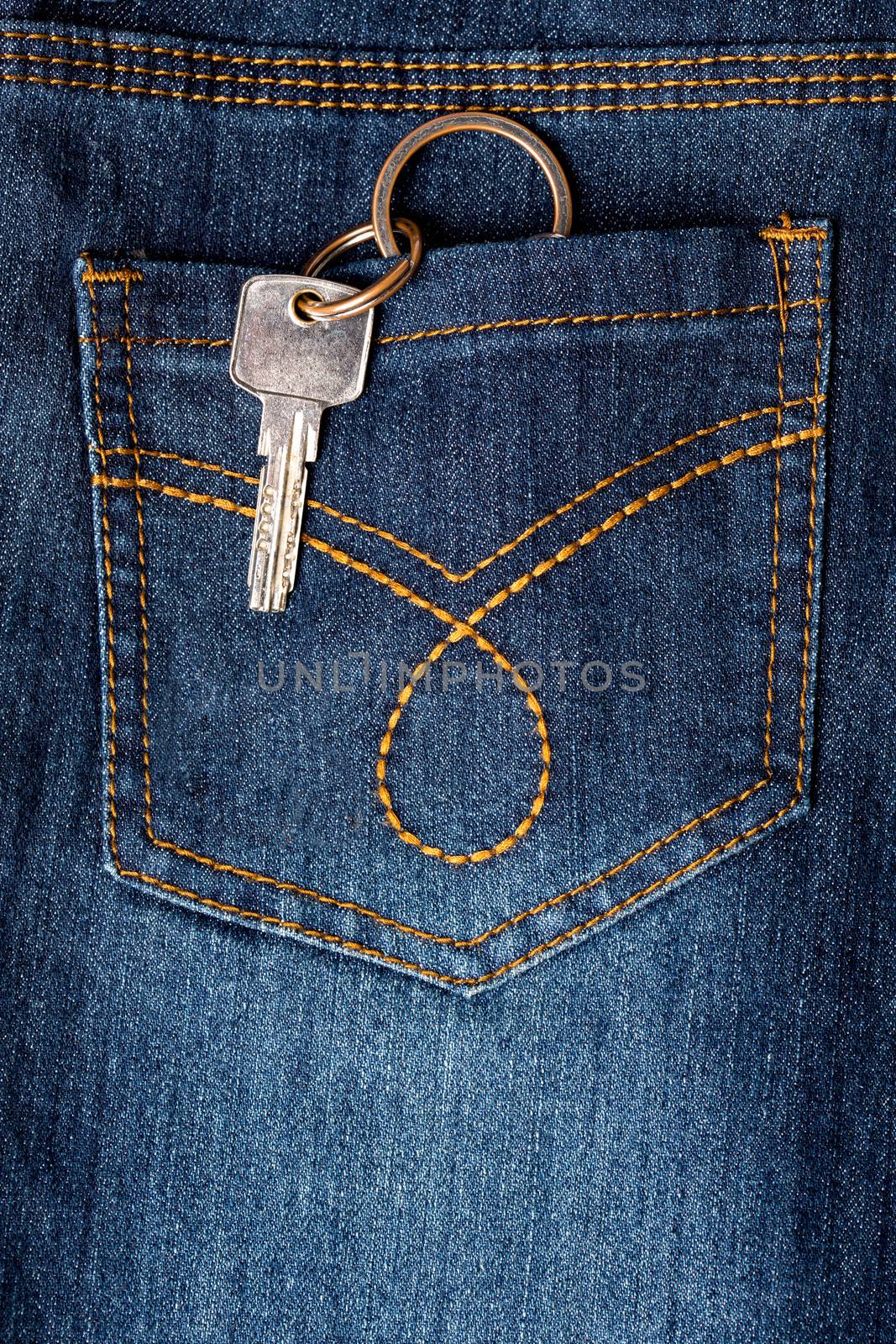Key hanging out of back pocket of a jeans by stockyimages