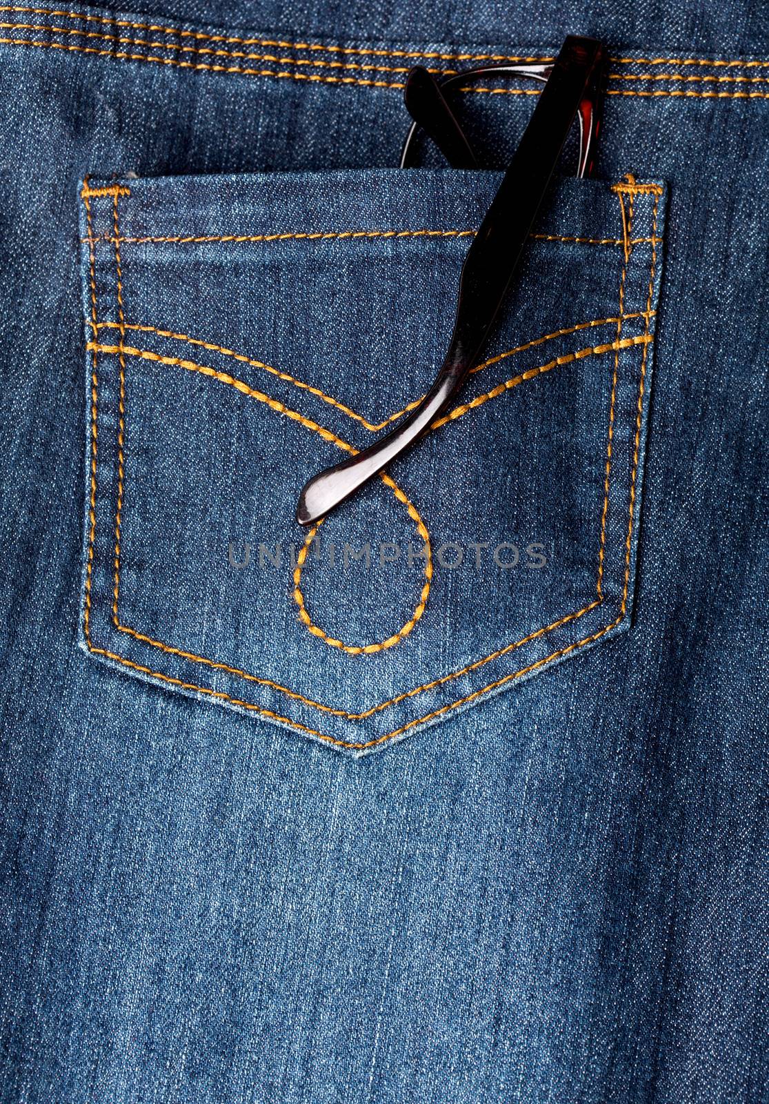 Eyeglasses in back pocket of jeans by stockyimages