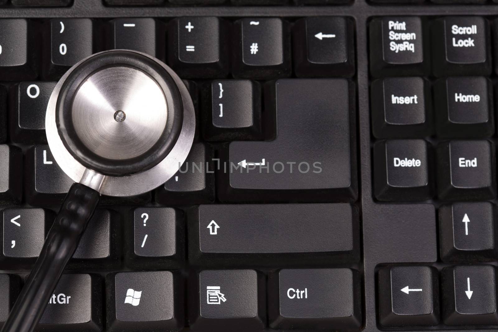 Stethoscope on computer keyboard to diagnose an issue