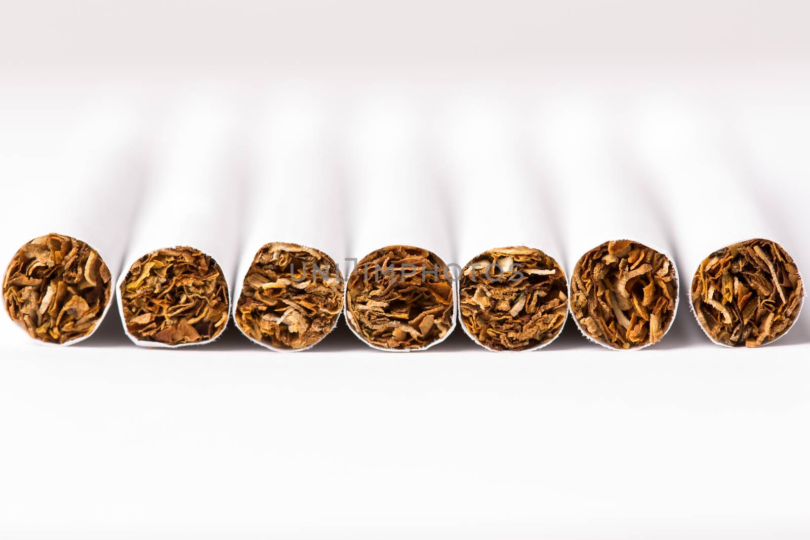 Cigarettes arranged in a row, a background by stockyimages