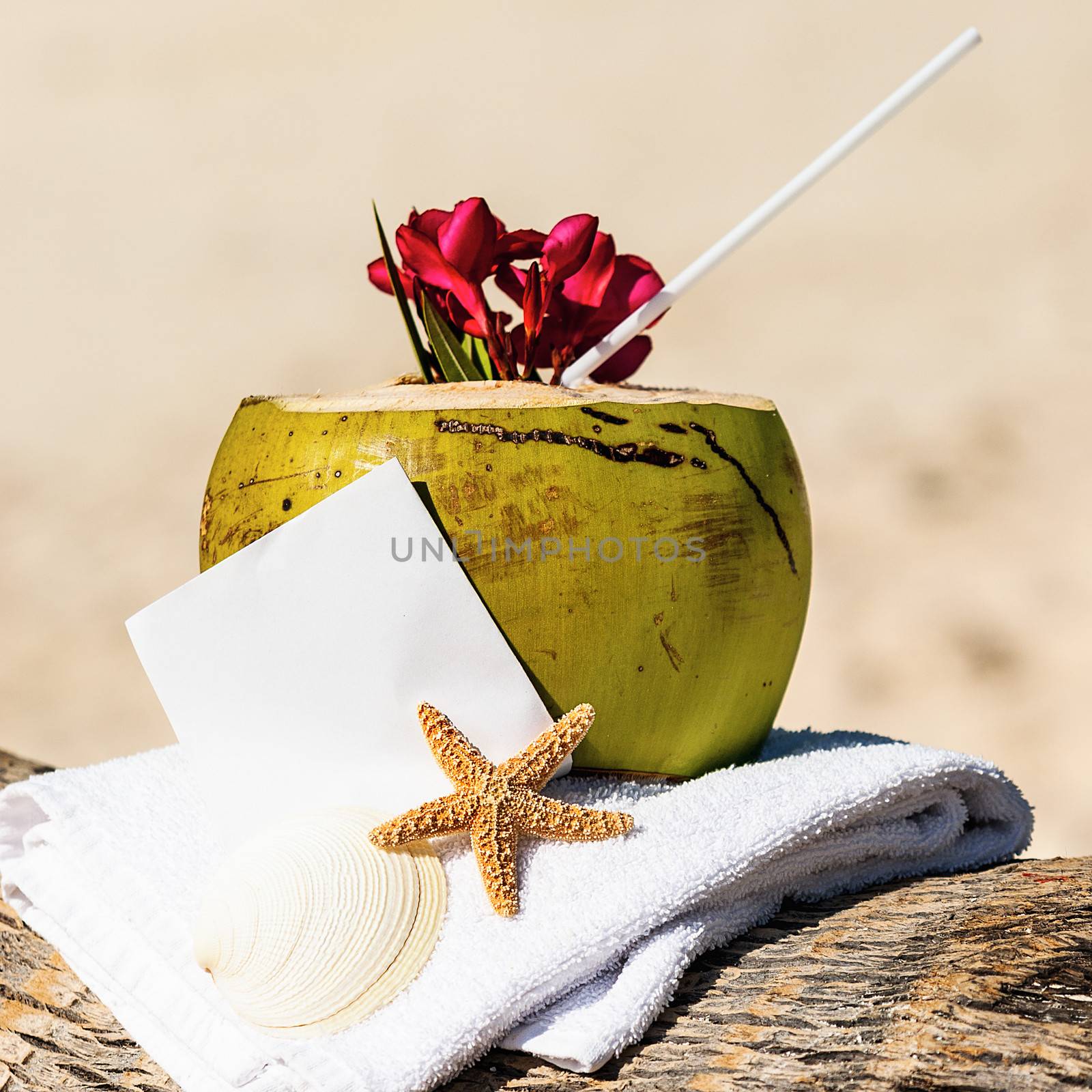 Coconut cocktail starfish tropical Caribbean beach refreshment and towel
