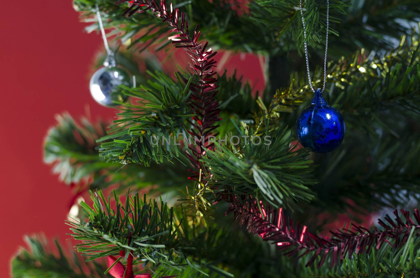 blue christmas ball on tree on red background by ammza12