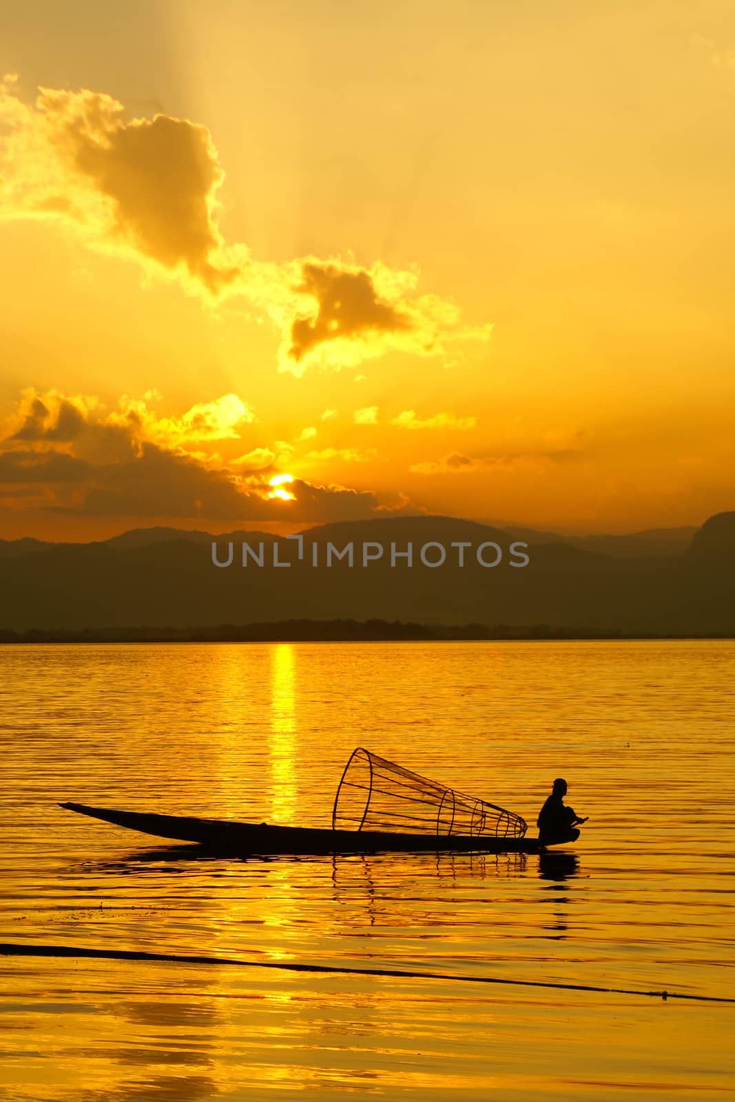 Sunset at Inle Lake with silhouette of fisherman, Myanmar, Asia