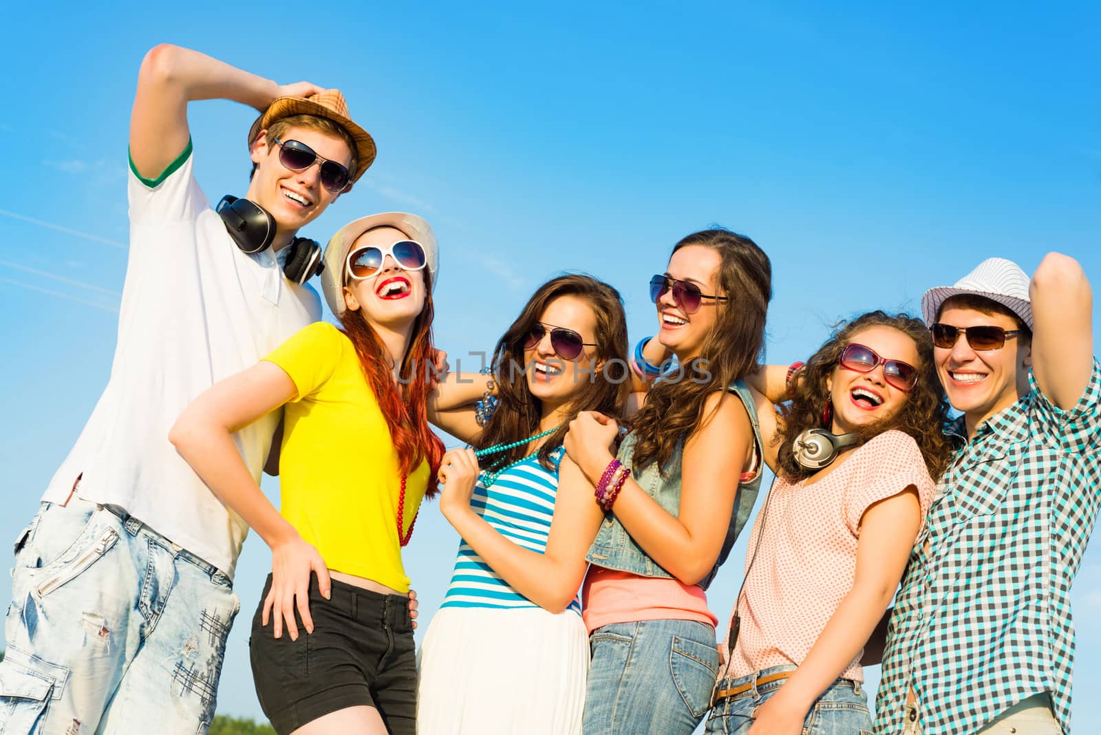 group of young people wearing sunglasses and hats hugging and standing in a row, spending time with friends