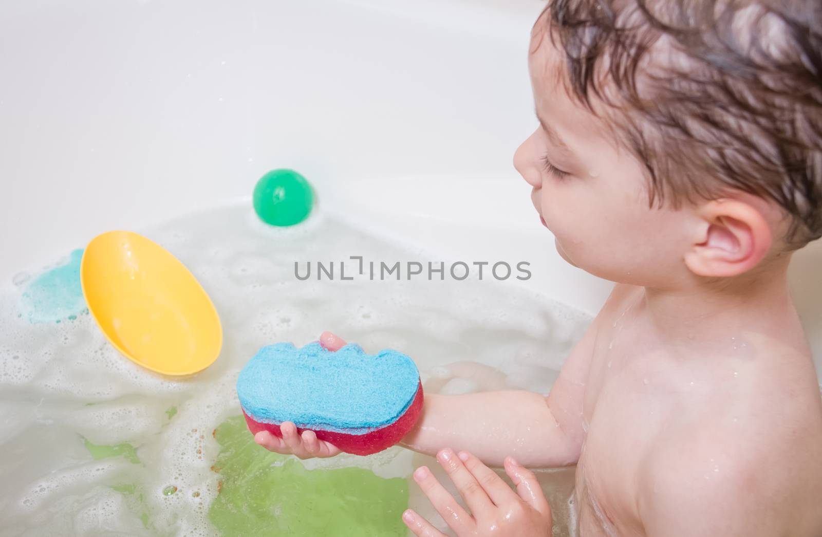 Cute boy happiness having bath in a bathtub