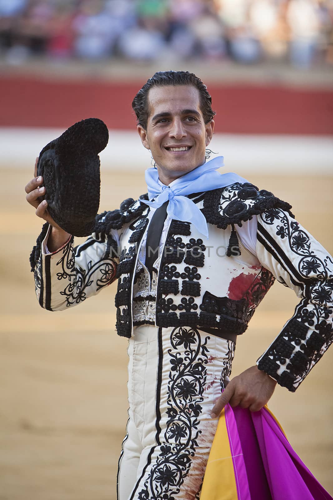 Baeza, Jaen province, SPAIN - 15 august 2010: Bullfighter Ivan Fandiño to the turning of honour with montera hat in his hand in the Bullring of Baeza, Jaen province, Andalusia, Spain