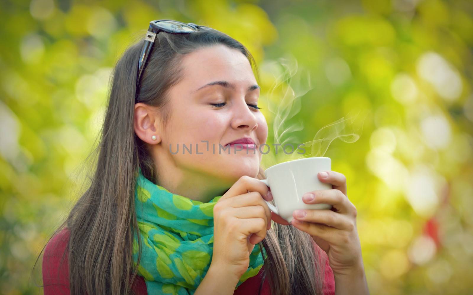 closeup portrait of a beautiful girl with a cup in nature