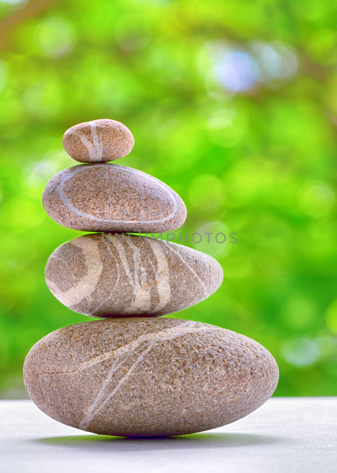 Stack of four stones isolated. stones in balanced pile