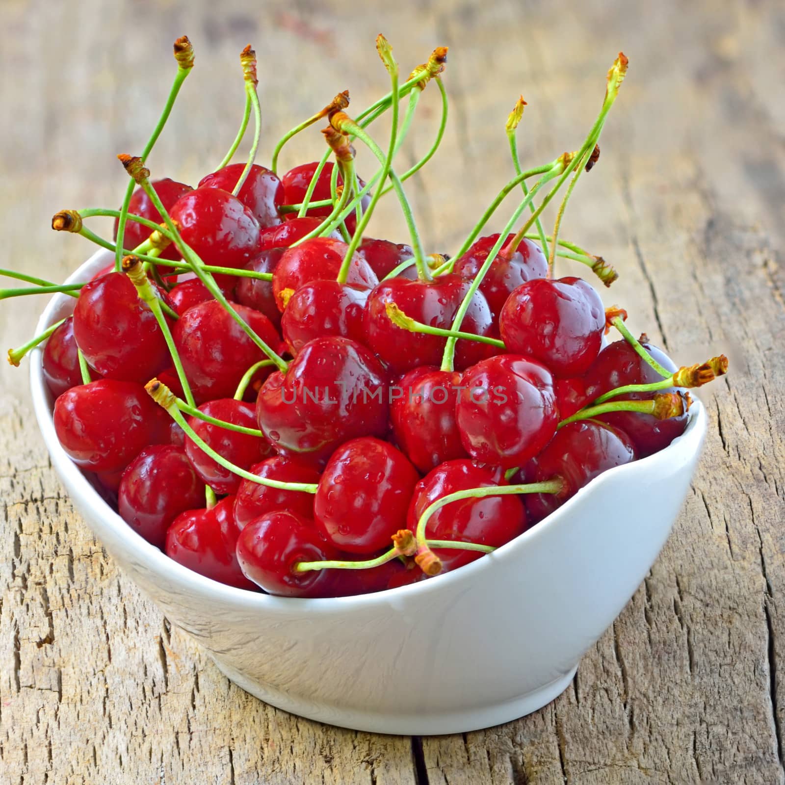 cherry bowl shoot in studio on old wooden background