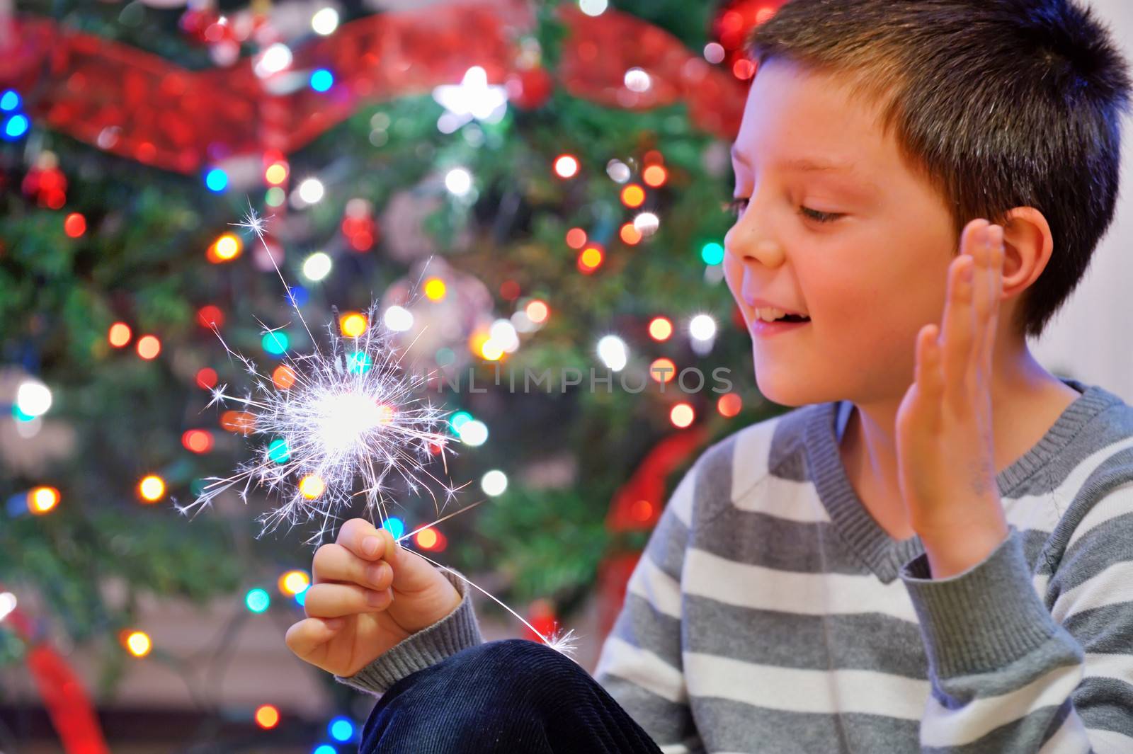 portrait of boy looking at  fire sparks by mady70