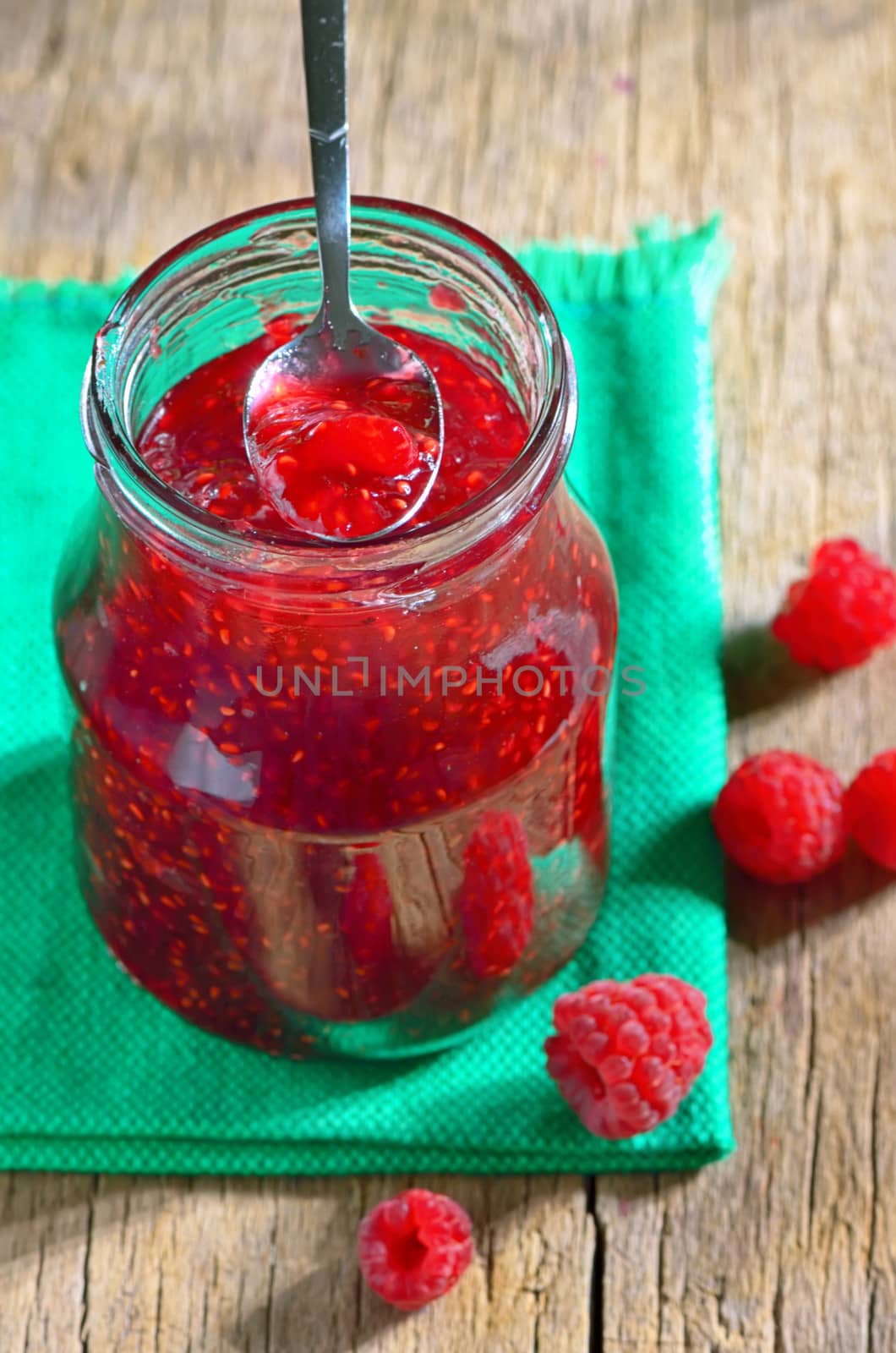 Homemade Raspberry Jam against a wooden background
