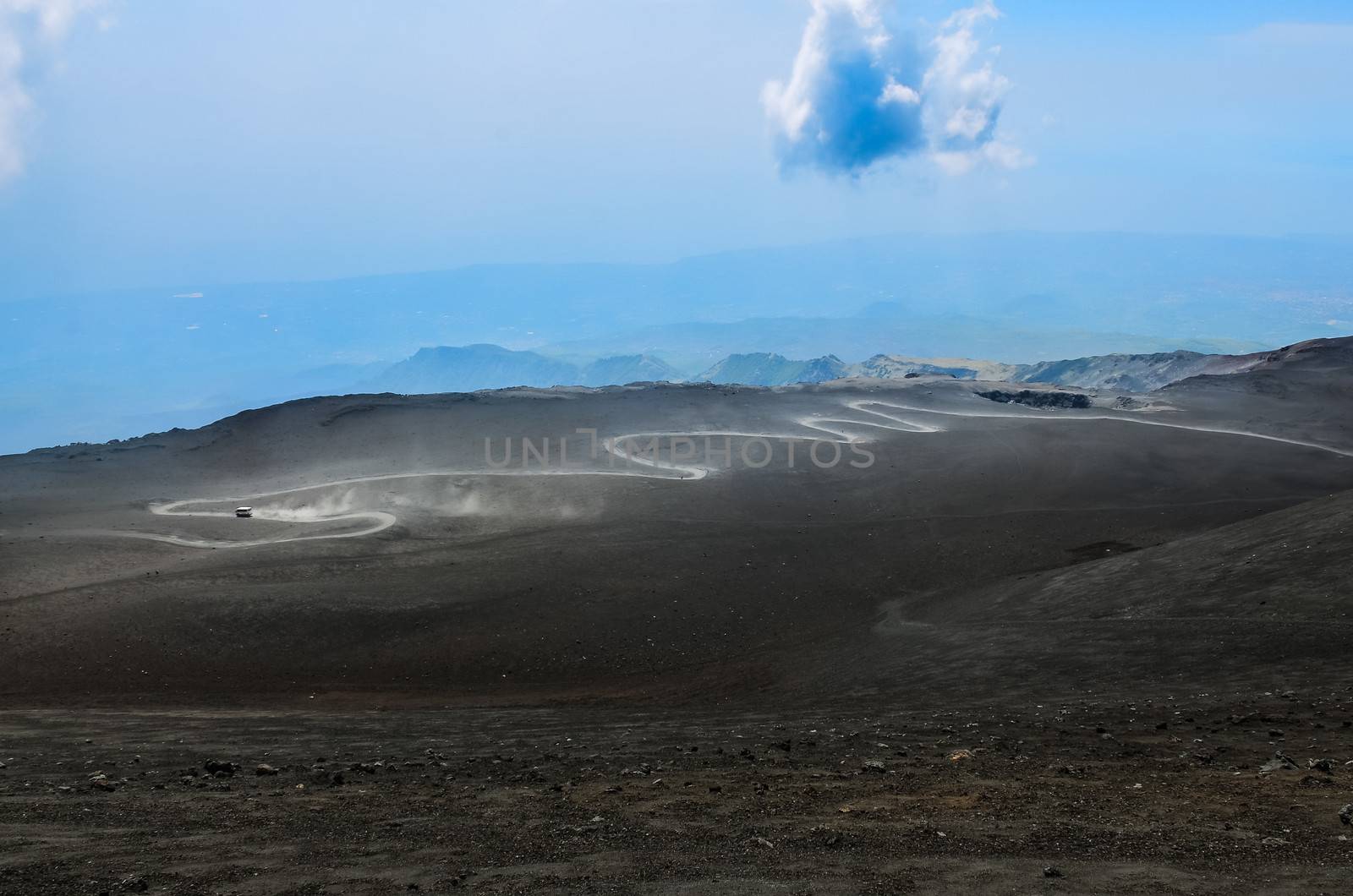 Dusty curvy road on Etna volcano, Sicily, Italy