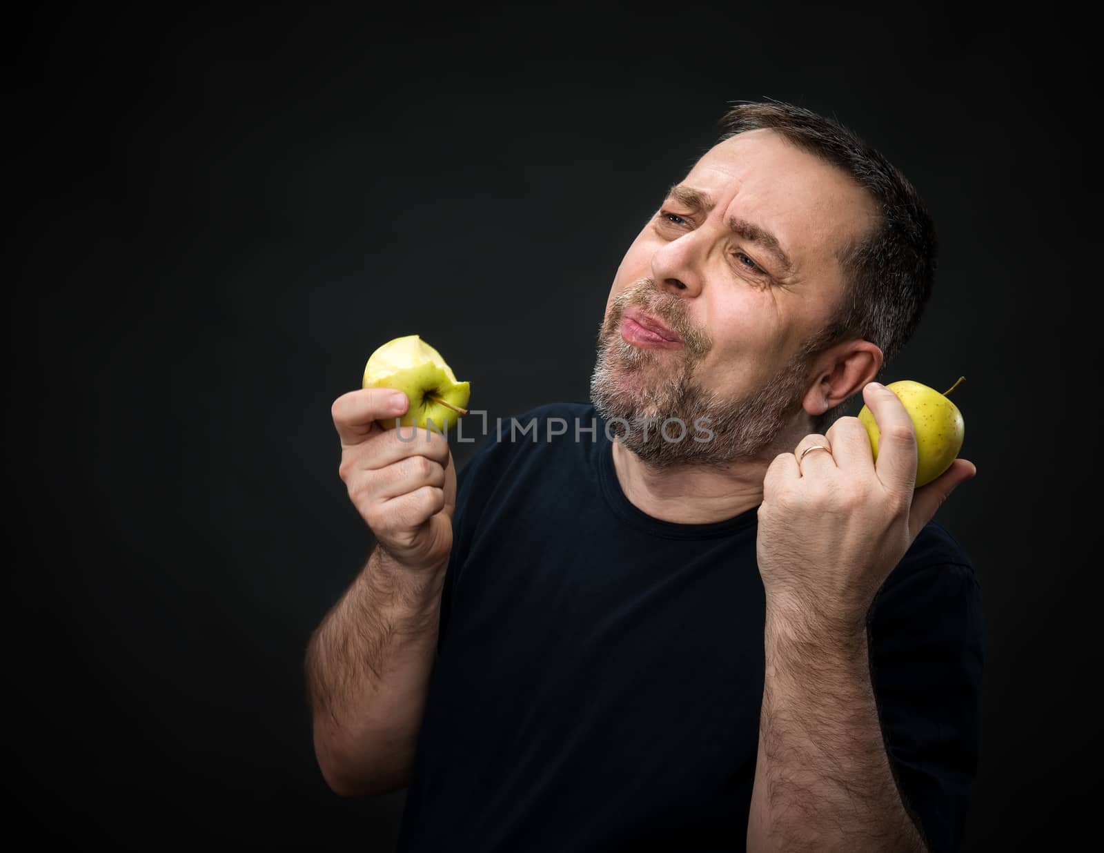 Middle-aged man with a green apples by palinchak