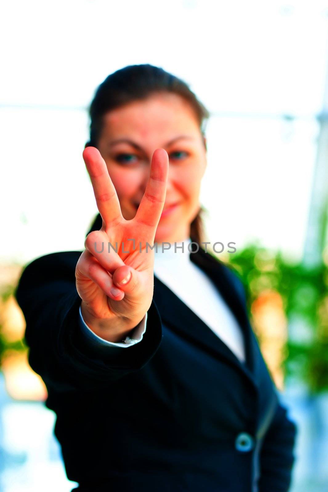Girl in a business suit showing gesture - victory hand by kosmsos111