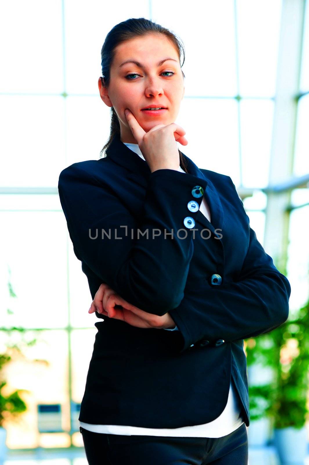Portrait of successful businesswoman smiling on the background of a blurred office interior by kosmsos111