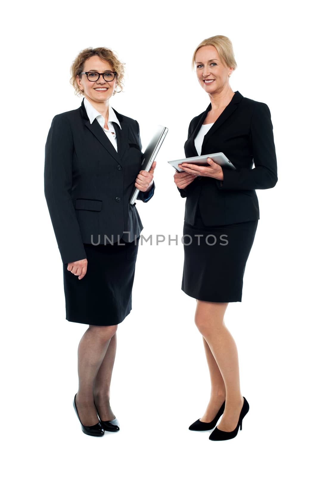 Two smiling businesswomen, full length portrait