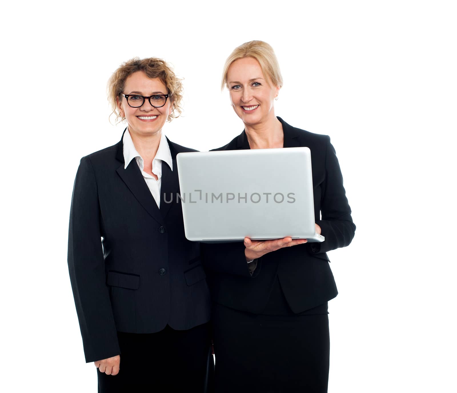 Two experienced business ladies working on laptop