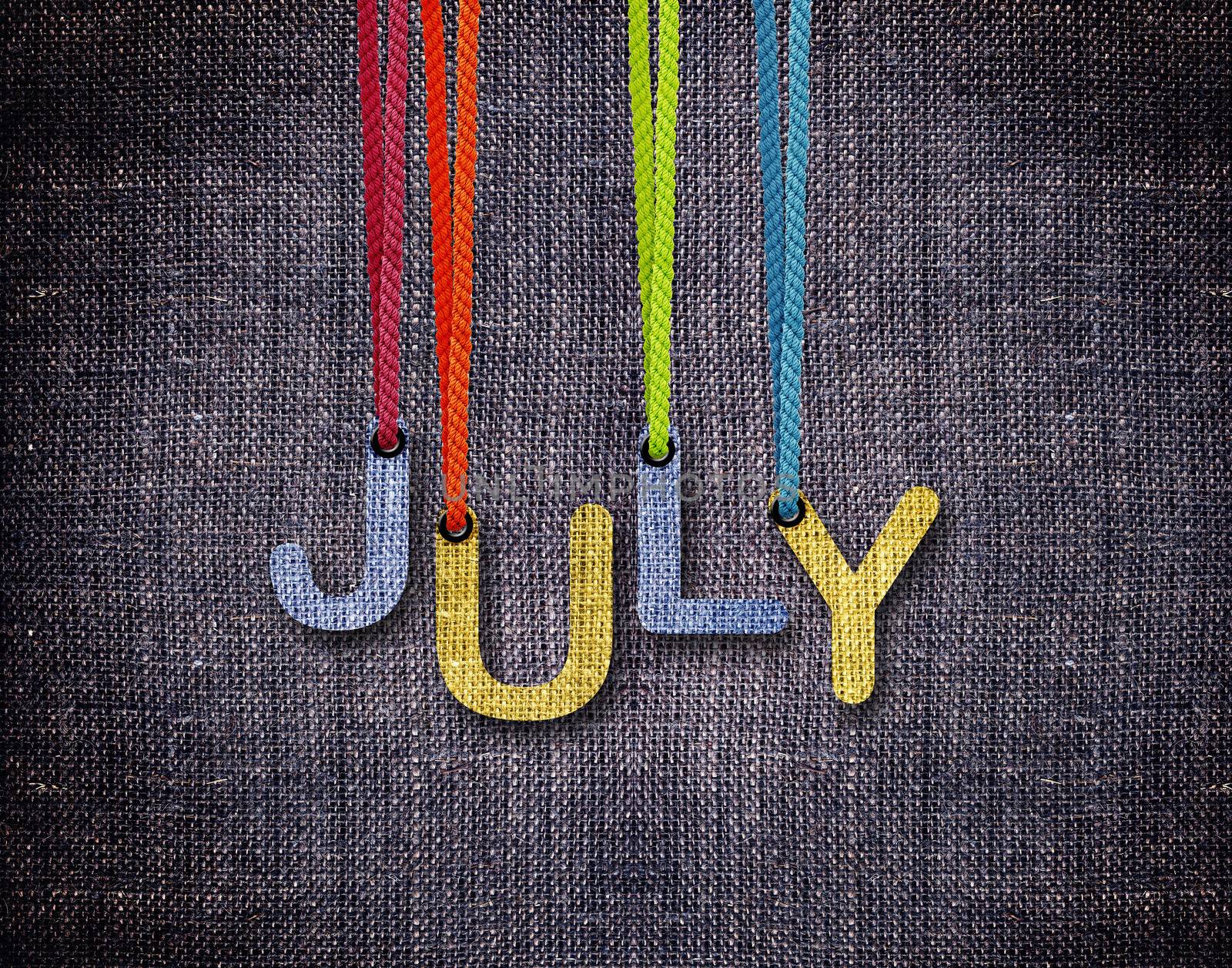 July letters hanging strings with blue sackcloth background.