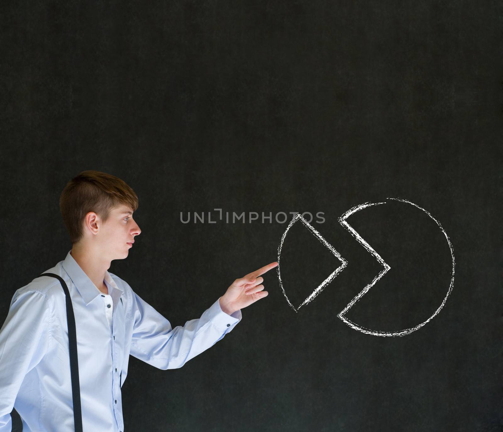 Sales businessman pushing chalk pie chart graph into place on blackboard background