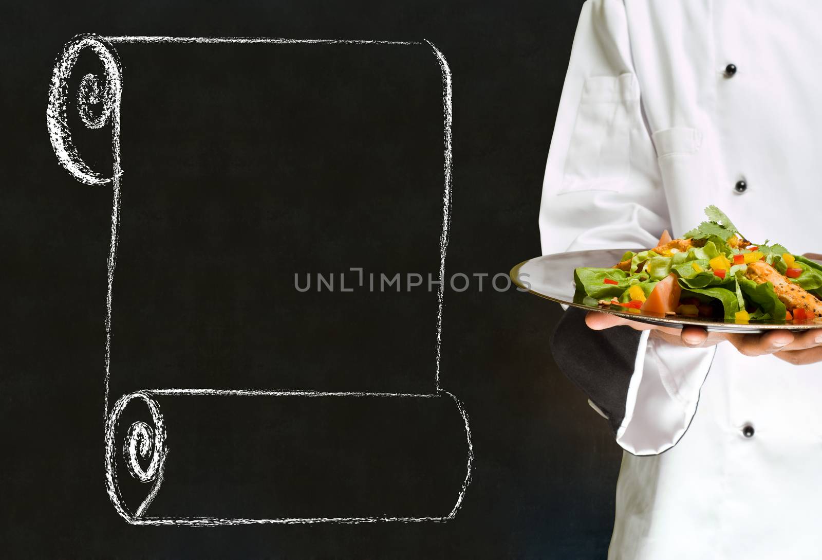 Chef holding health salad dish with chalk scroll on blackboard Background by alistaircotton