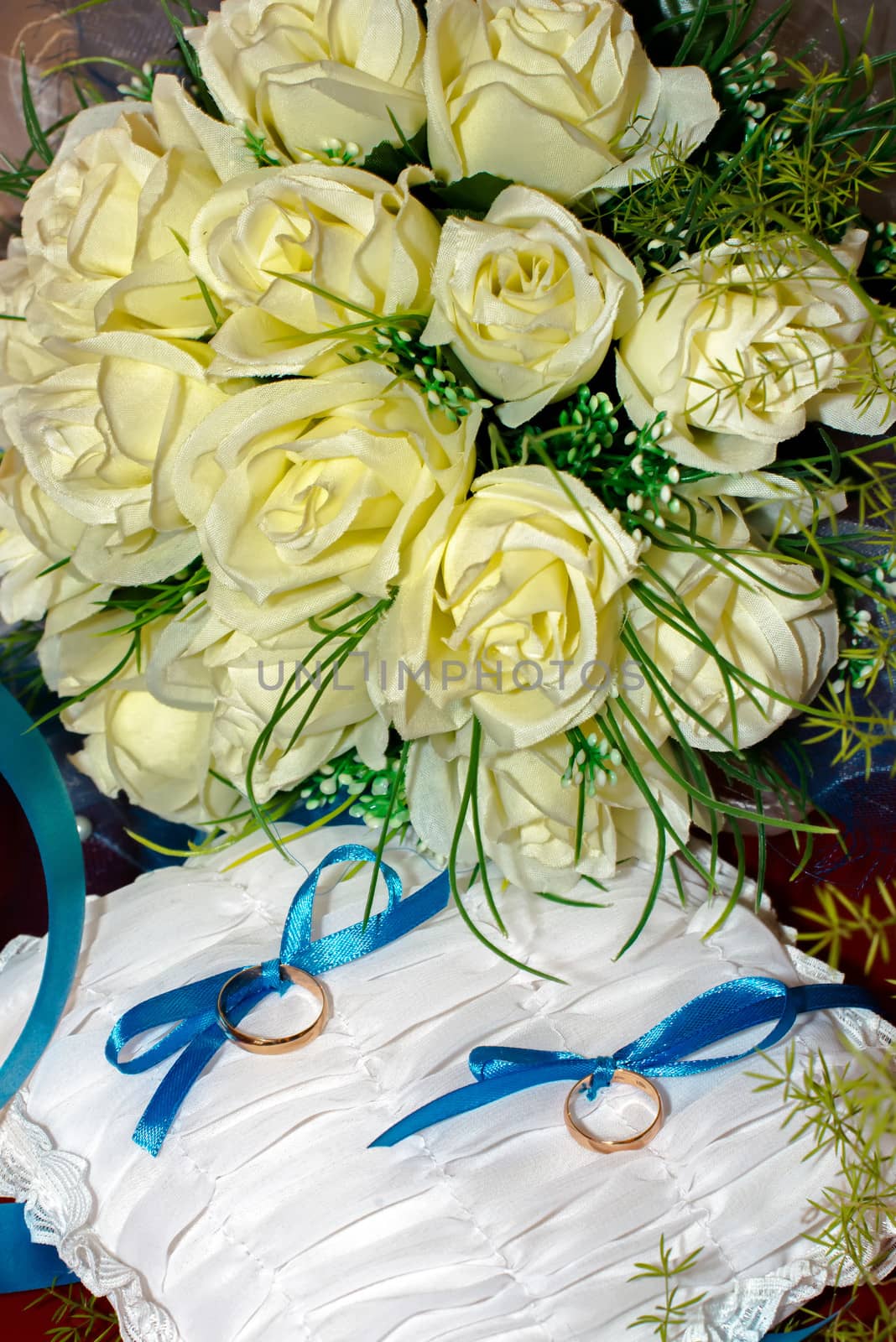 two wedding rings lie on a background of flowers