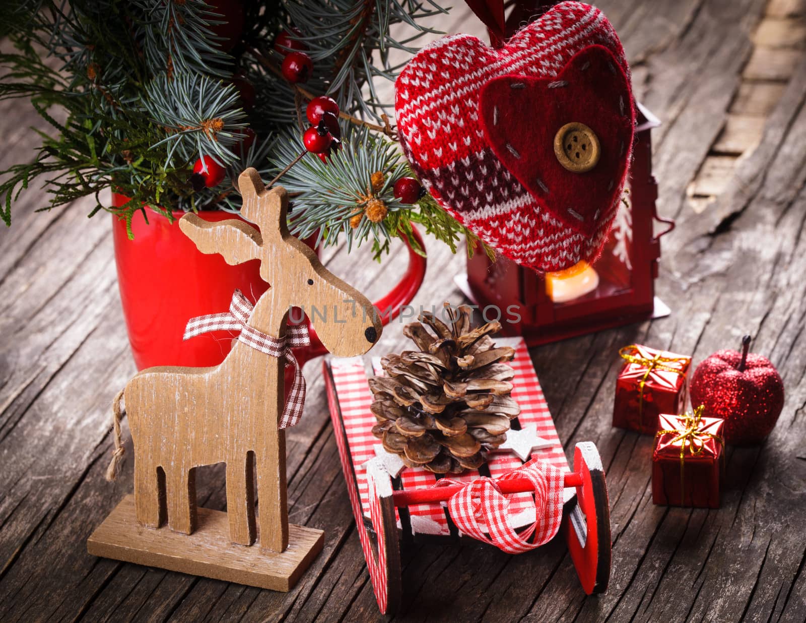 Christmas decorations: heart, deer and sleds on old wooden table