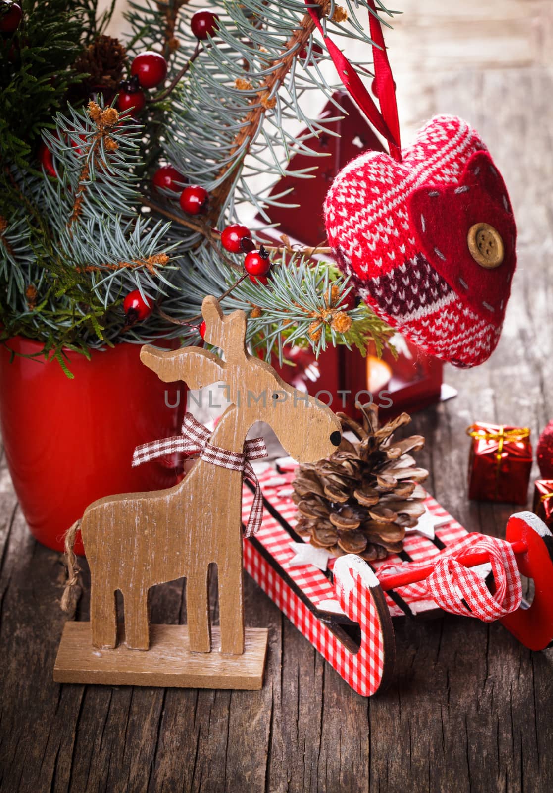 Christmas decorations: heart, deer and sleds on old wooden table