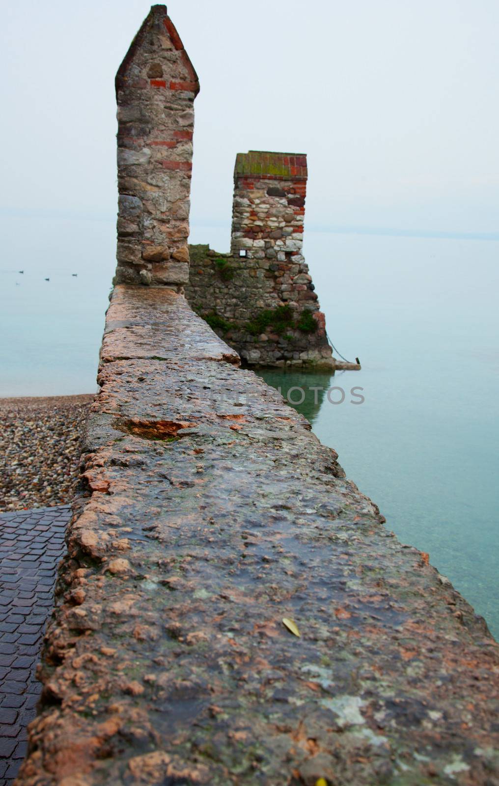 A castle wall extending over the lake