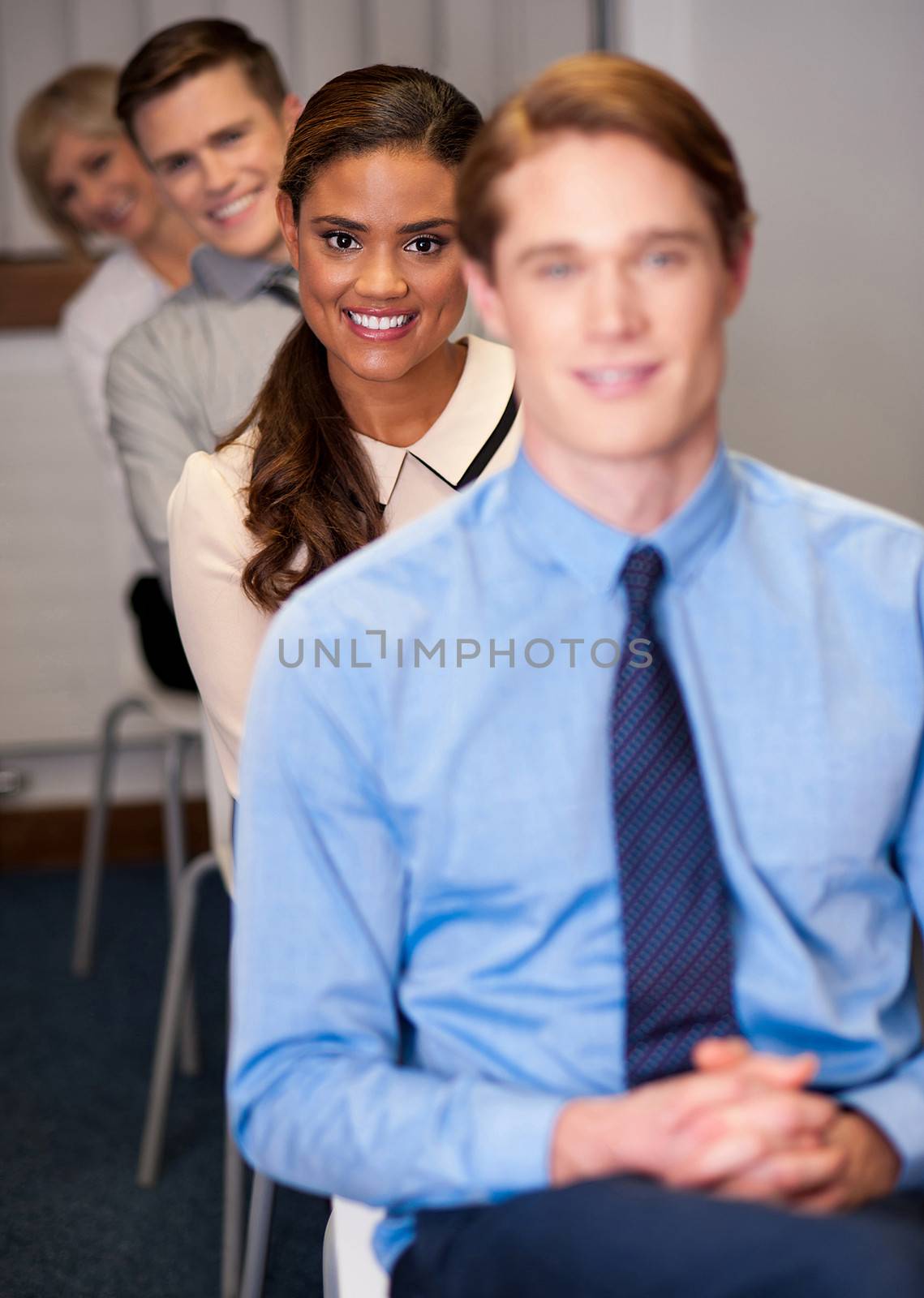 Happy smiling business team sitting in a row