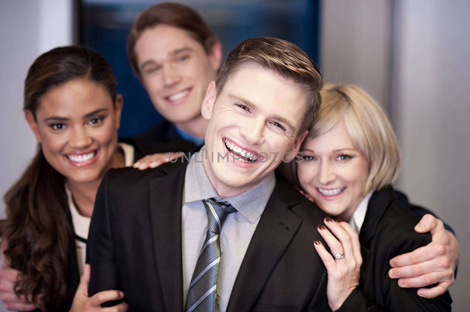 Business team of four having fun at work by stockyimages