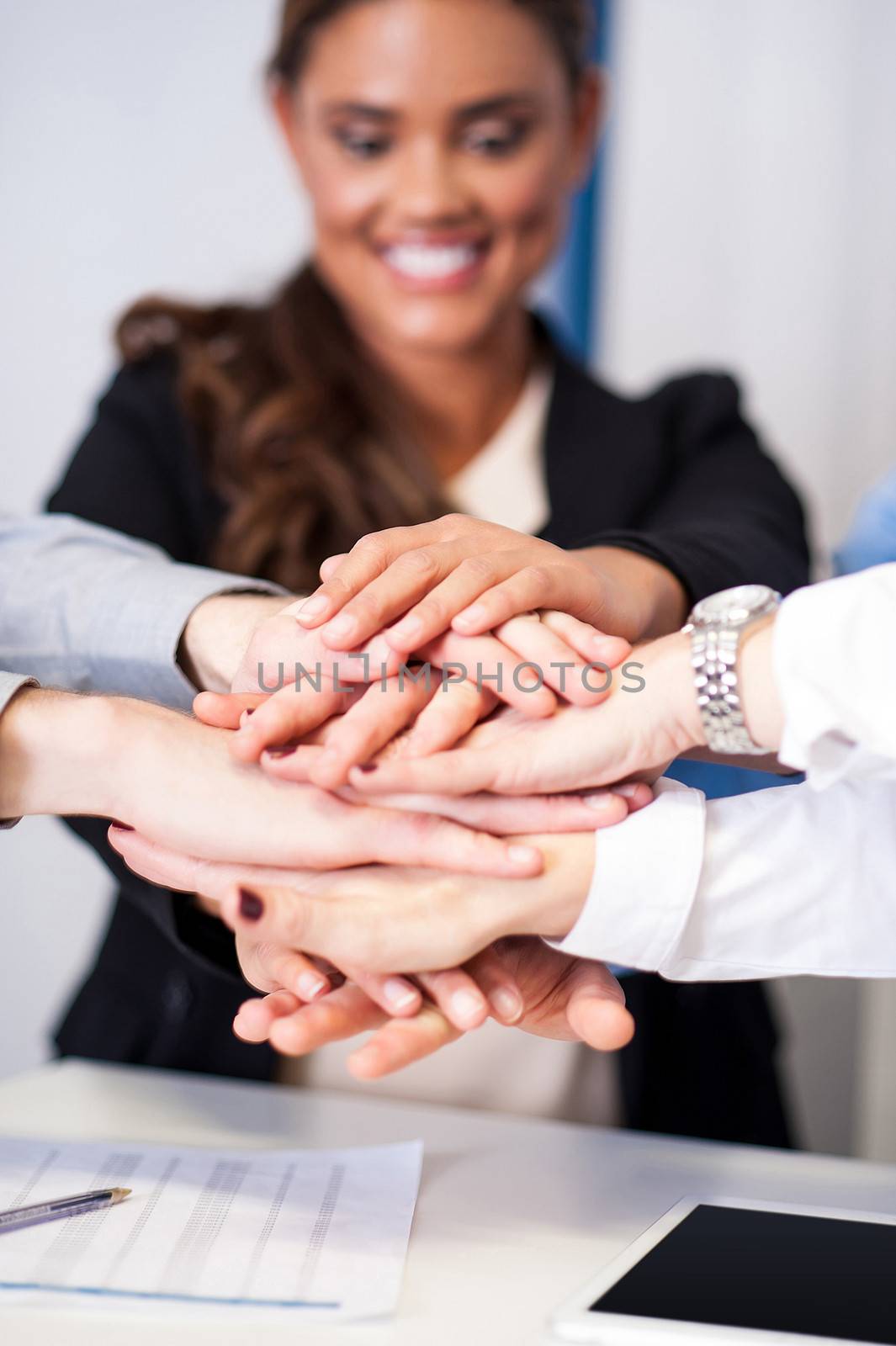 Business team stacking hands by stockyimages