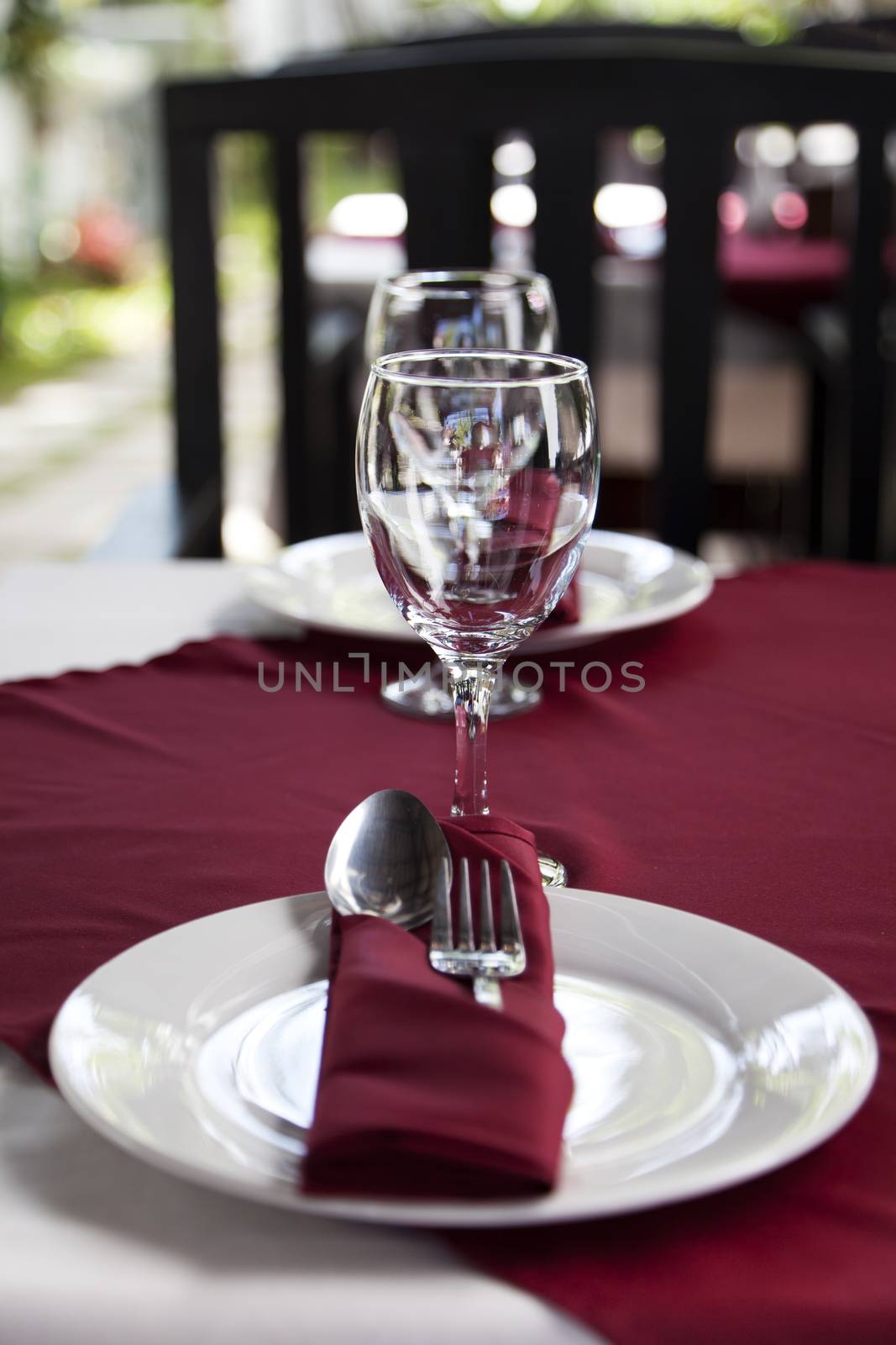 Restaurant table with plates and  spoon and fork sets