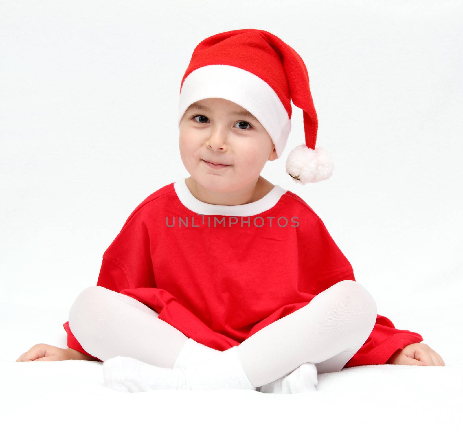 beautiful child in santa claus hat by NikolayK