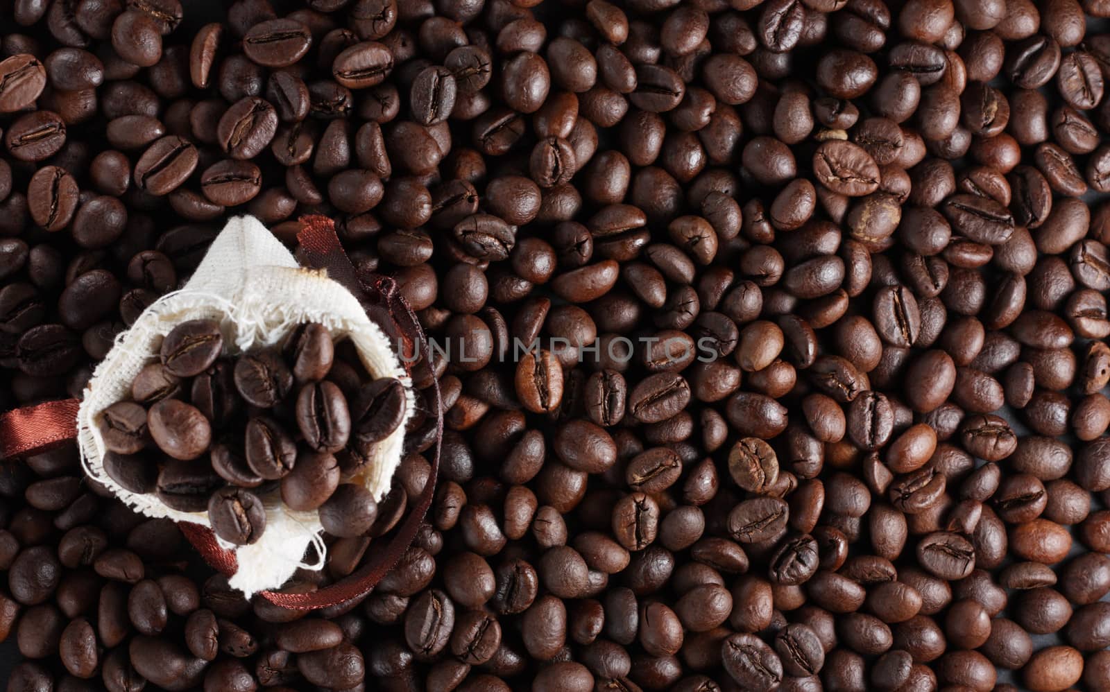 Coffee beans in a sack by dedmorozz