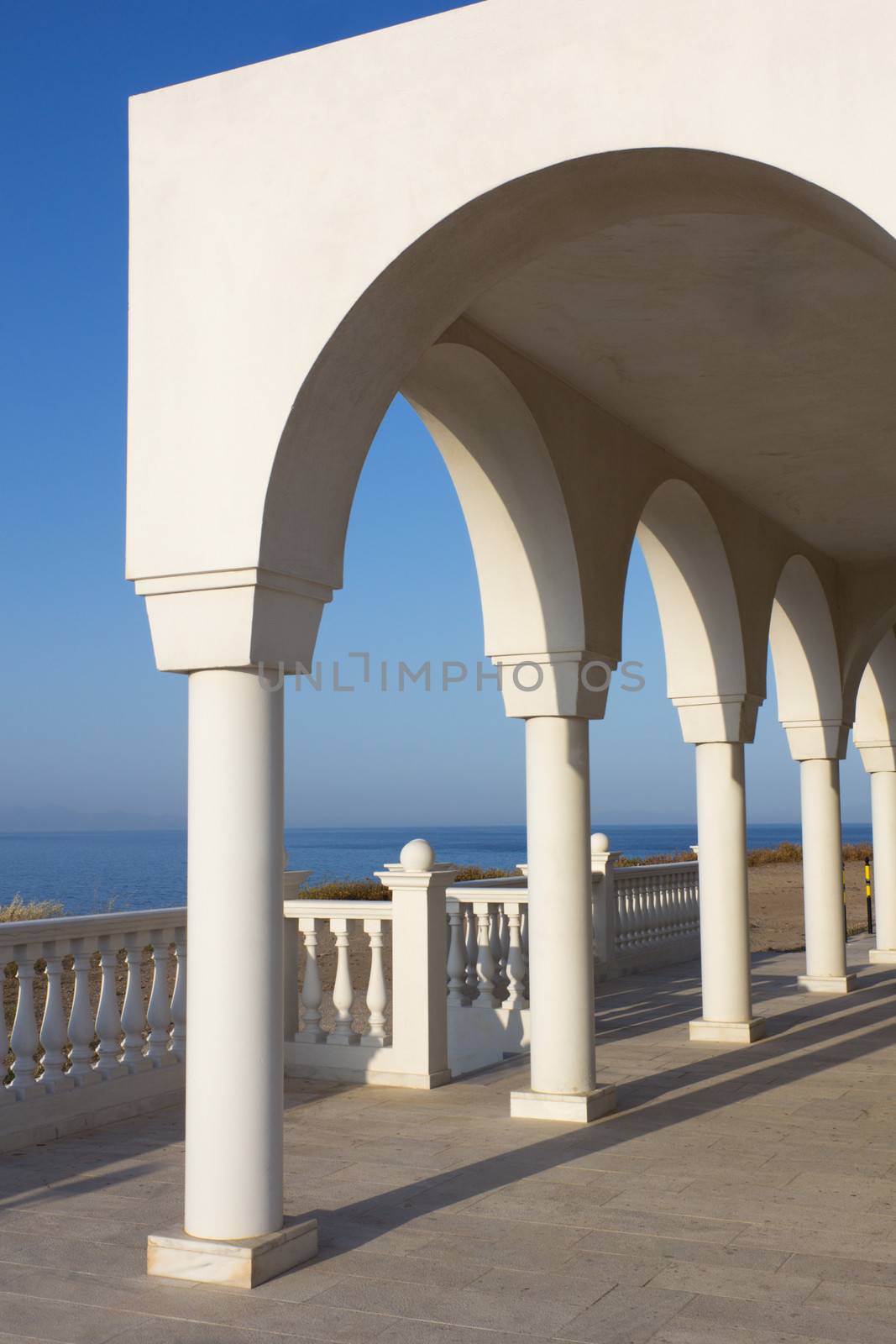 View over the Aegean Sea from the porch with arches and columns of orthodox church Profitis Ilias in Keratea, near Lavrio, in East Attika, Greece.