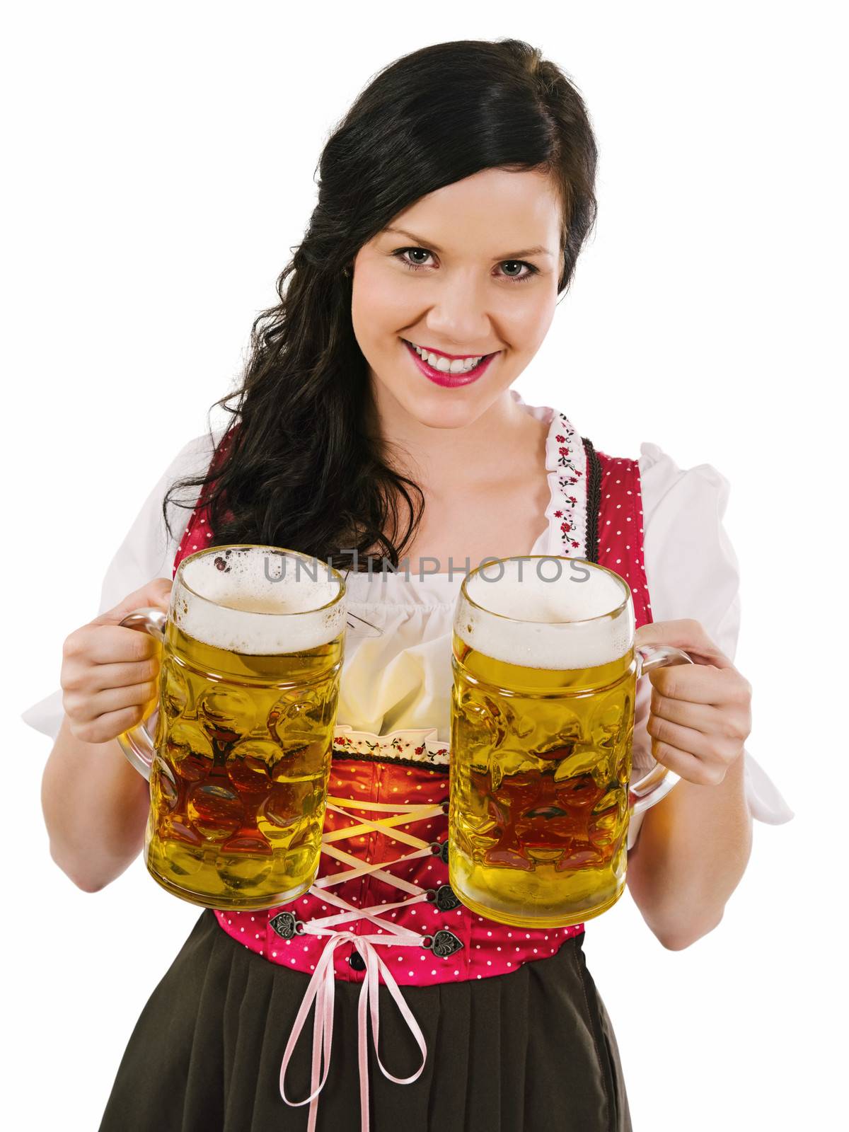 Photo of a beautiful woman wearing traditional dirndl and serving beer.