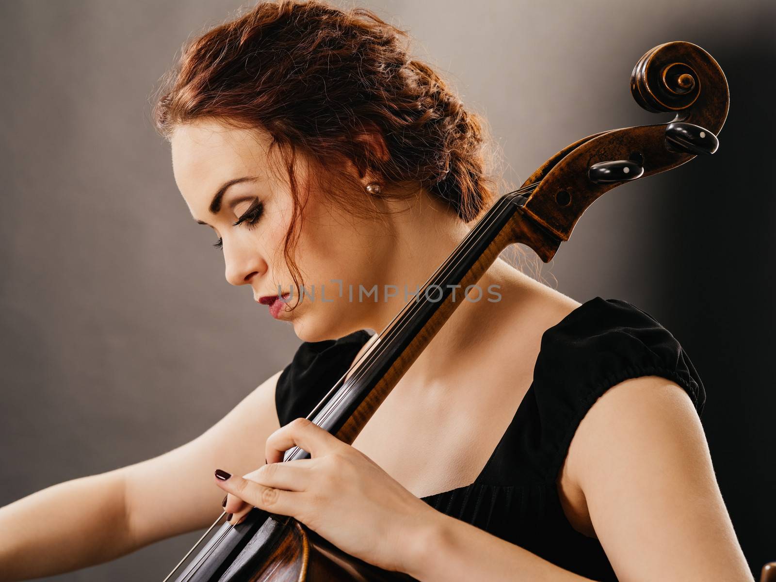 Photo of a beautiful woman playing a cello.
