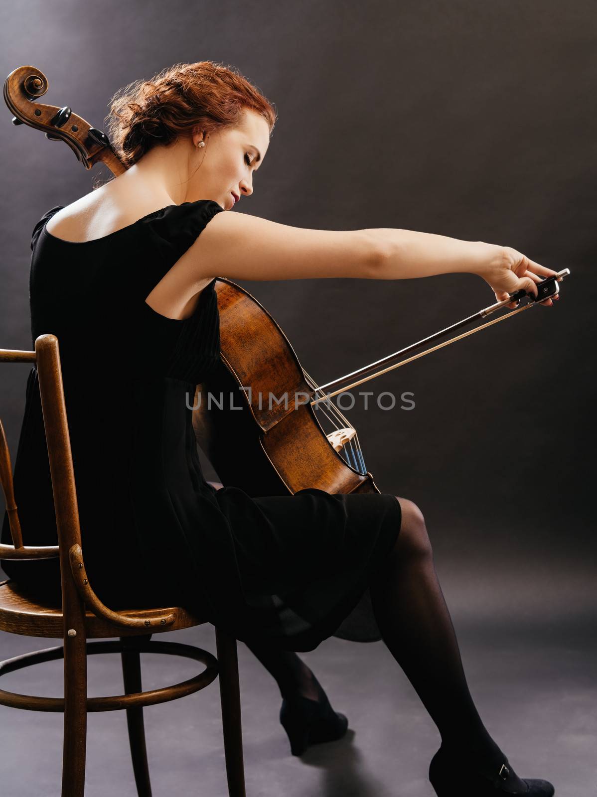 Photo of a beautiful woman playing a cello.
