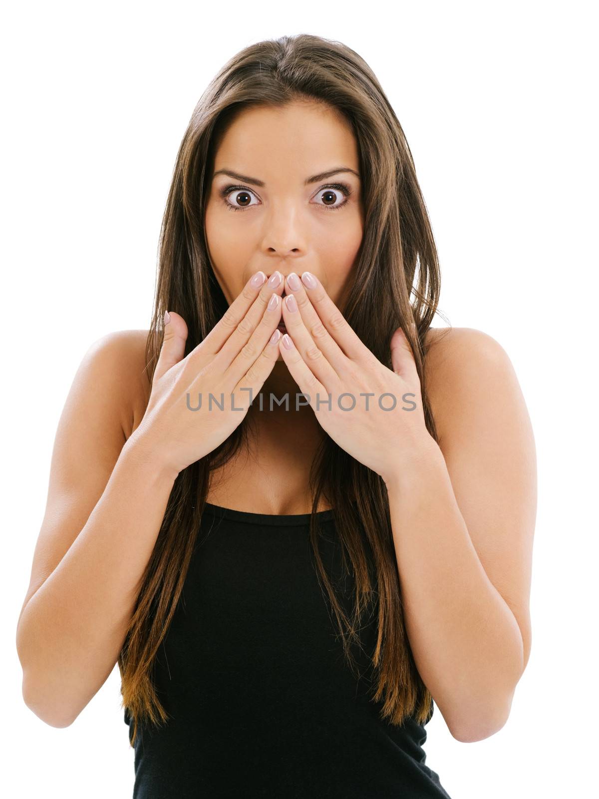 Photo of a beautiful woman with her hands over her mouth and eyes wide from shock.