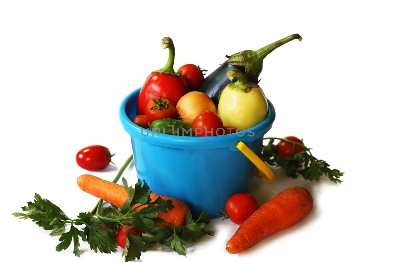 Different vegetables in a plastic pail isolated on the white