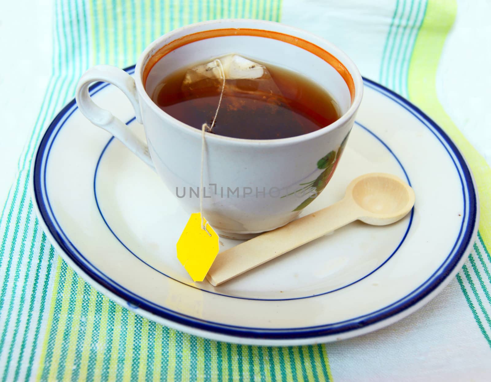 Cup of hot tea on tablecloths.Cup of hot tea