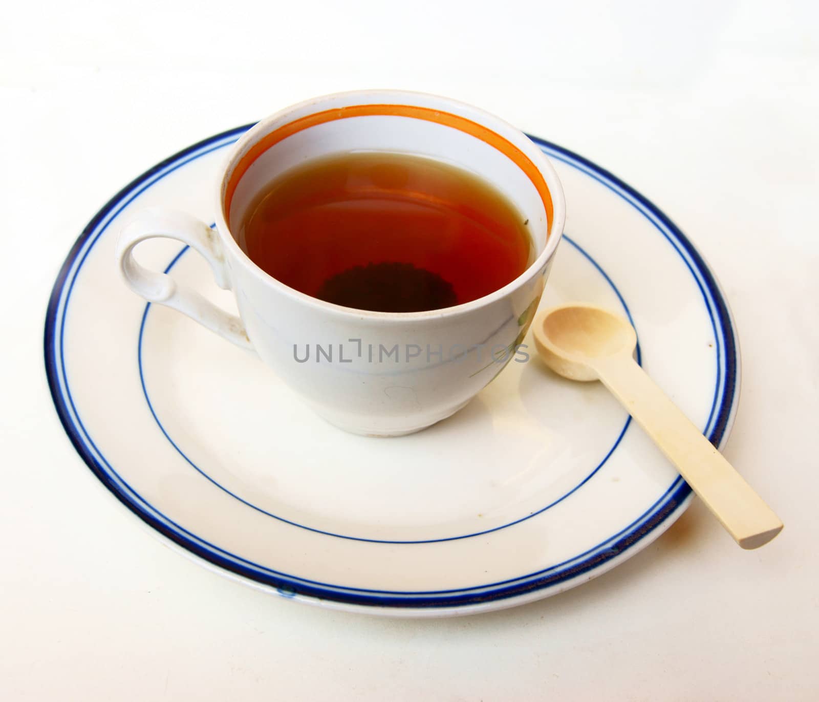 Cup of tea on saucer on white background