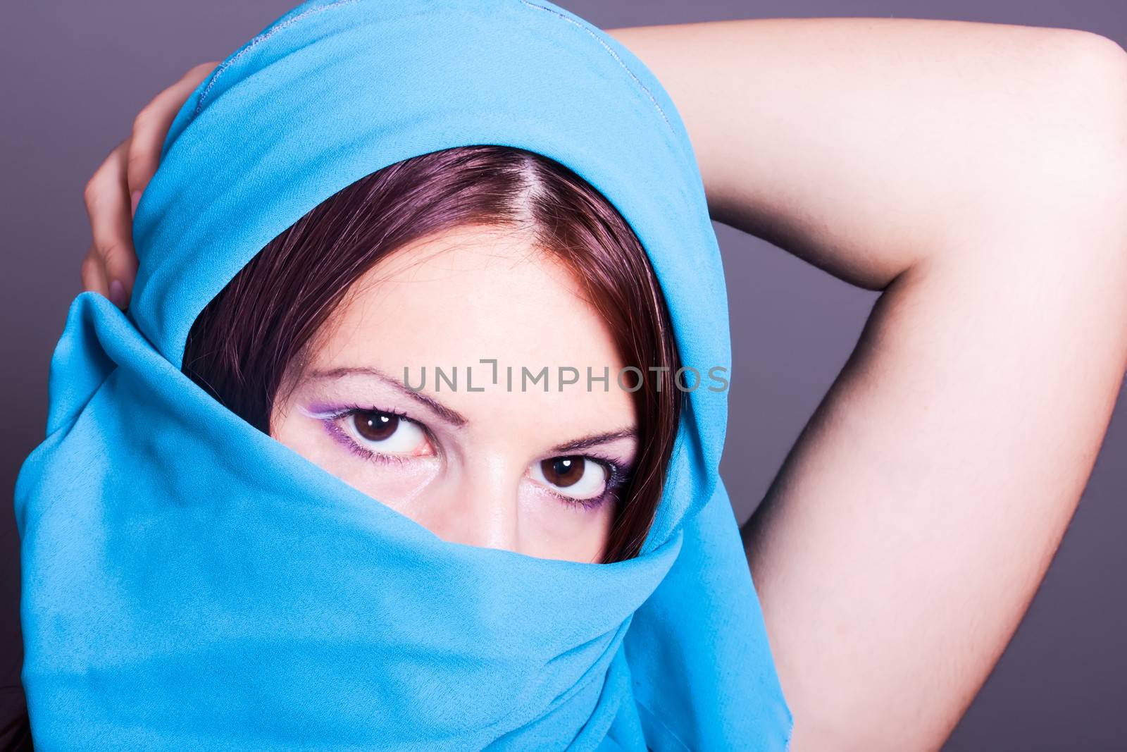 portrait of beautiful woman with a blue veil